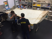 examine-piece-of-aircraft-debris-2_july2016