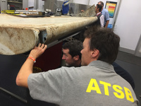 examine-piece-of-aircraft-debris-3_july2016